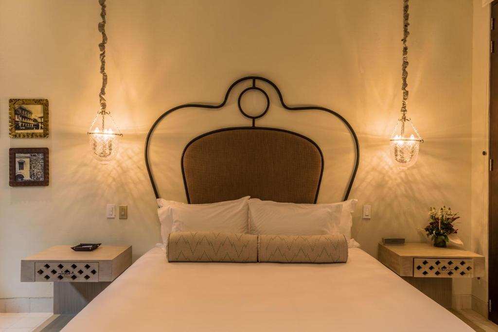 Postel nebo postele na pokoji v ubytování Hotel Capellán de Getsemaní