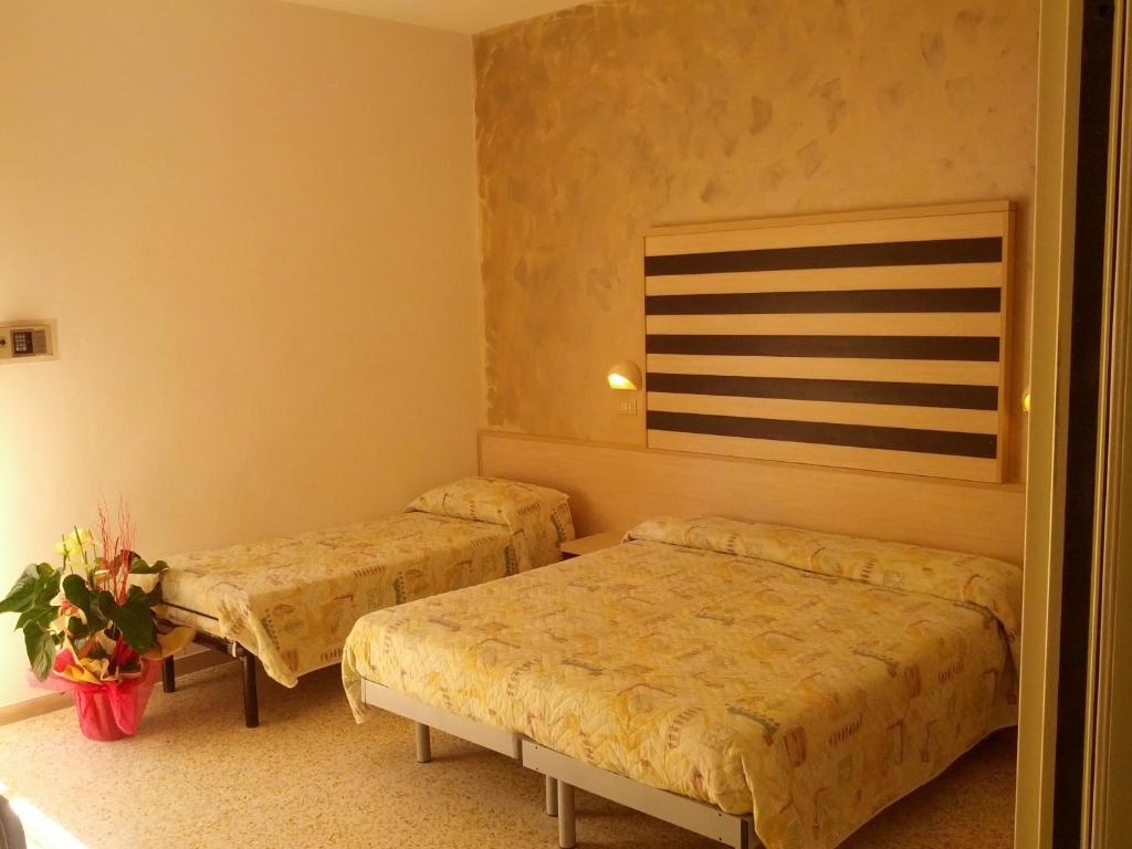 Postel nebo postele na pokoji v ubytování Hotel Abel & Residence