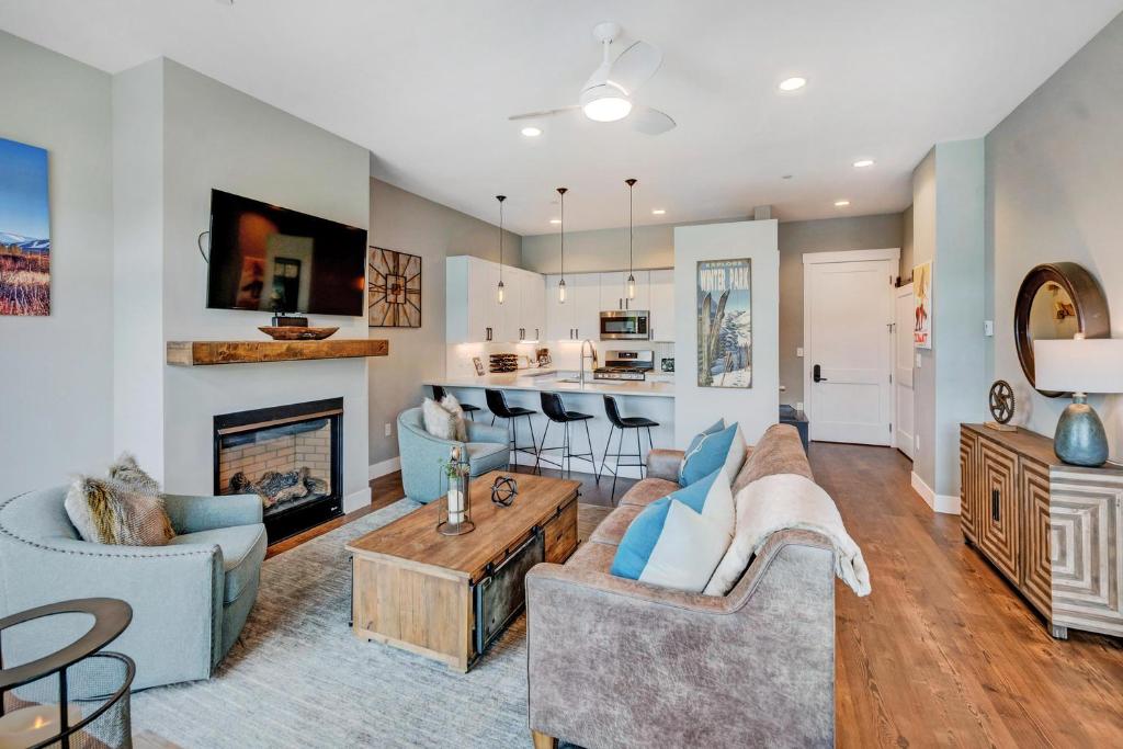 a living room with a couch and a fireplace at New Luxury Loft #10 - Huge Hot Tub & Great Views - 500 Dollars Of FREE Activities & Equipment Rentals Daily in Winter Park