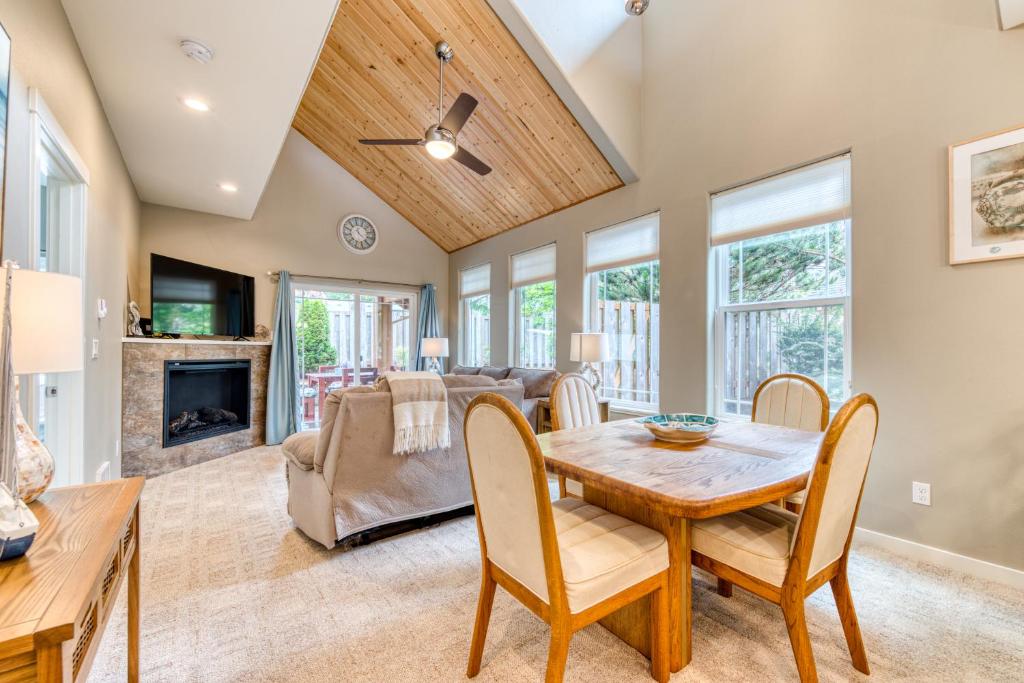 a dining room with a table and chairs and a fireplace at Lake & Ocean in Rockaway Beach