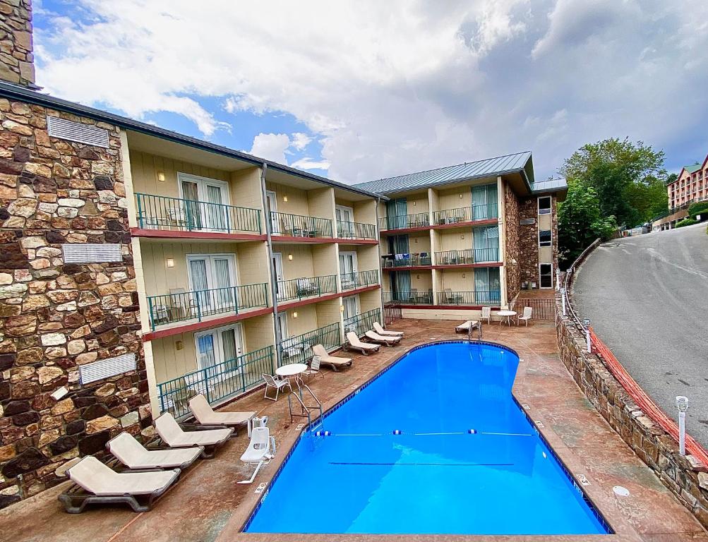 a view of a hotel with a swimming pool and chairs at Reagan Resorts Inn in Gatlinburg