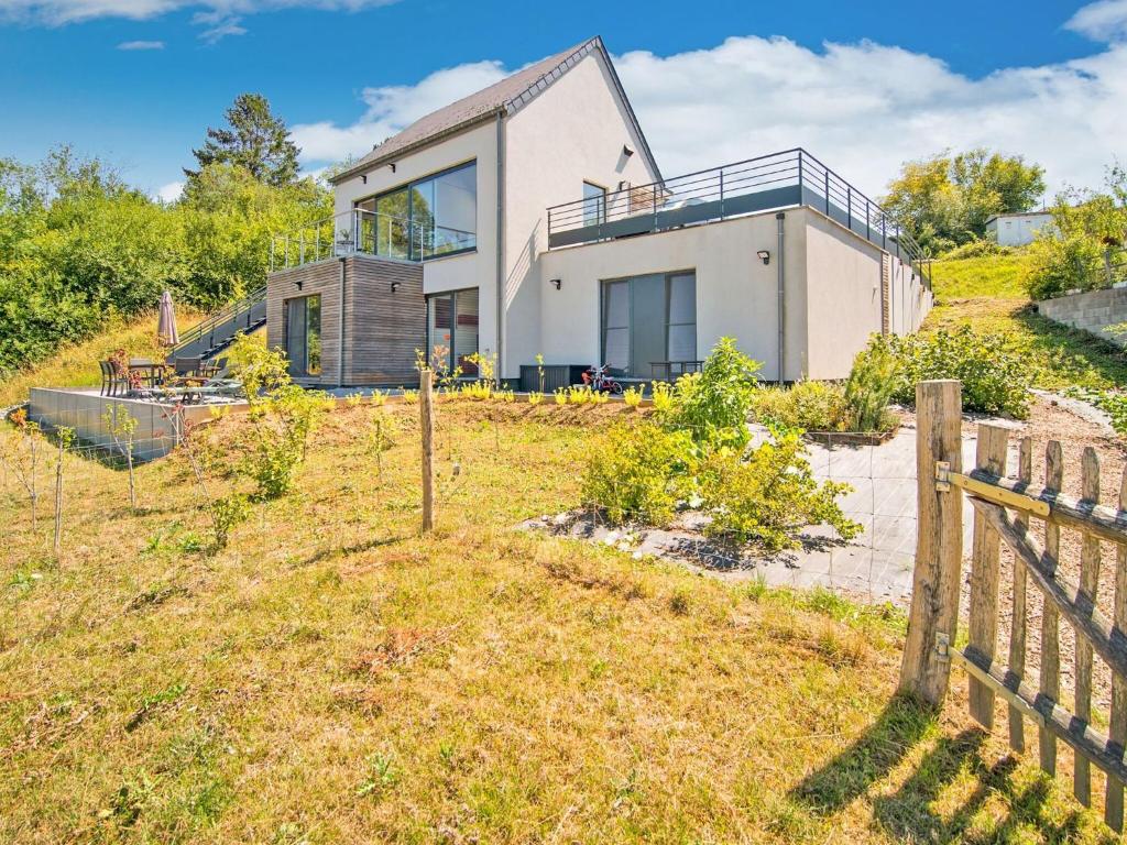 uma casa no topo de uma colina com uma cerca em Holiday home Viroinval em Petigny