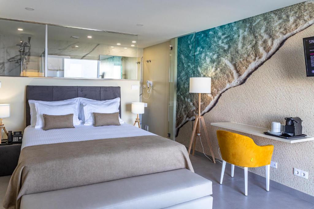 a bedroom with a bed and a painting on the wall at Lagos Atlantic Hotel in Lagos
