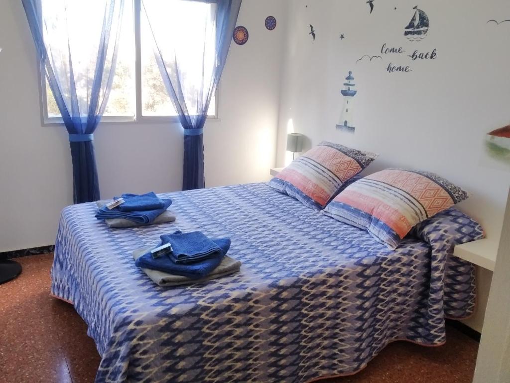 a bedroom with a bed with blue towels on it at Quiet Stay Gran Canaria in Playa del Burrero