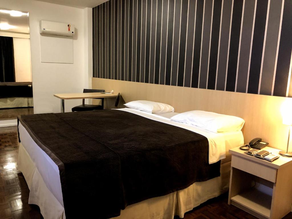 A bed or beds in a room at 155 Hotel