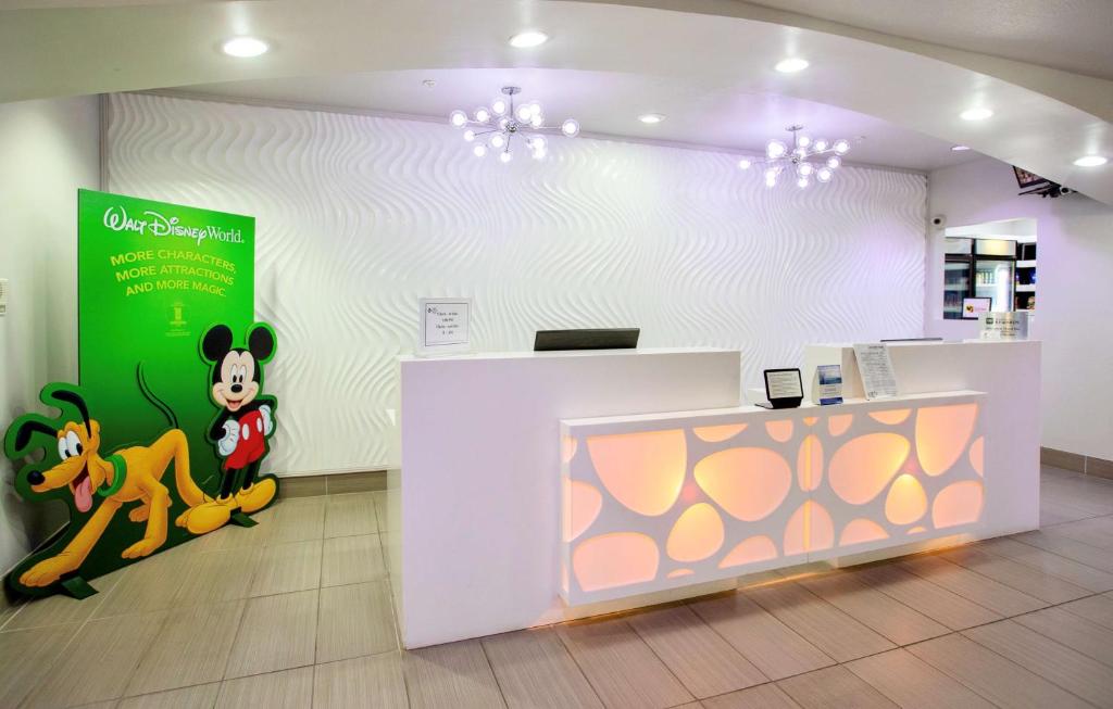 a store with a mickey mouse sign on the wall at Best Western Plus Orlando Lake Buena Vista South Inn & Suites in Kissimmee