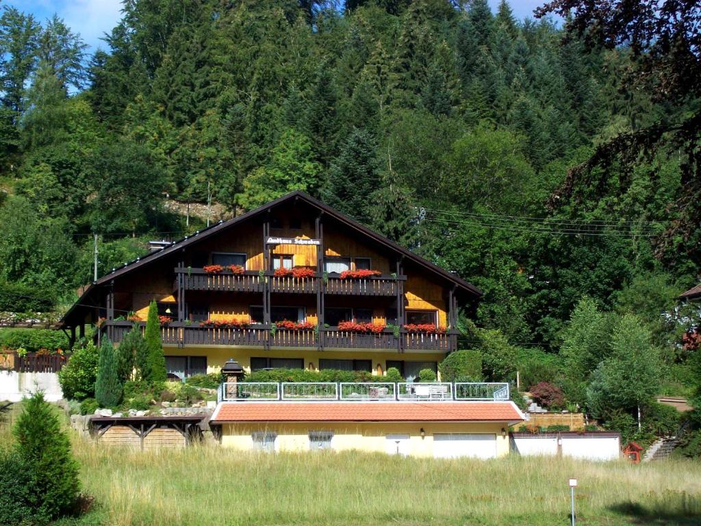 a large house with a balcony on top of it at Landhaus Schwaben in Schönmünzach