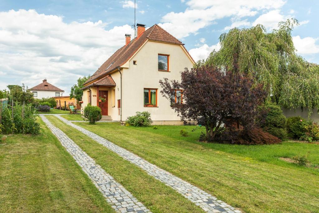 a house with a stone path in front of a yard at VS apartmán in Turnov