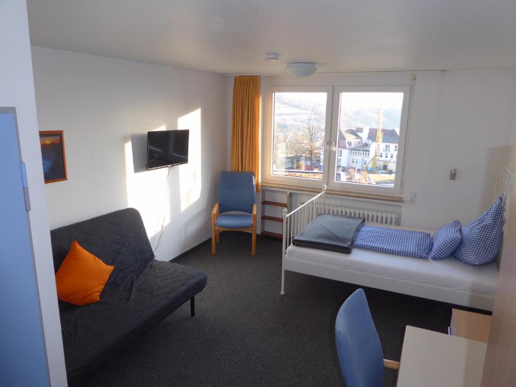 a living room with a couch and a window at Comfort Apartment in Tübingen