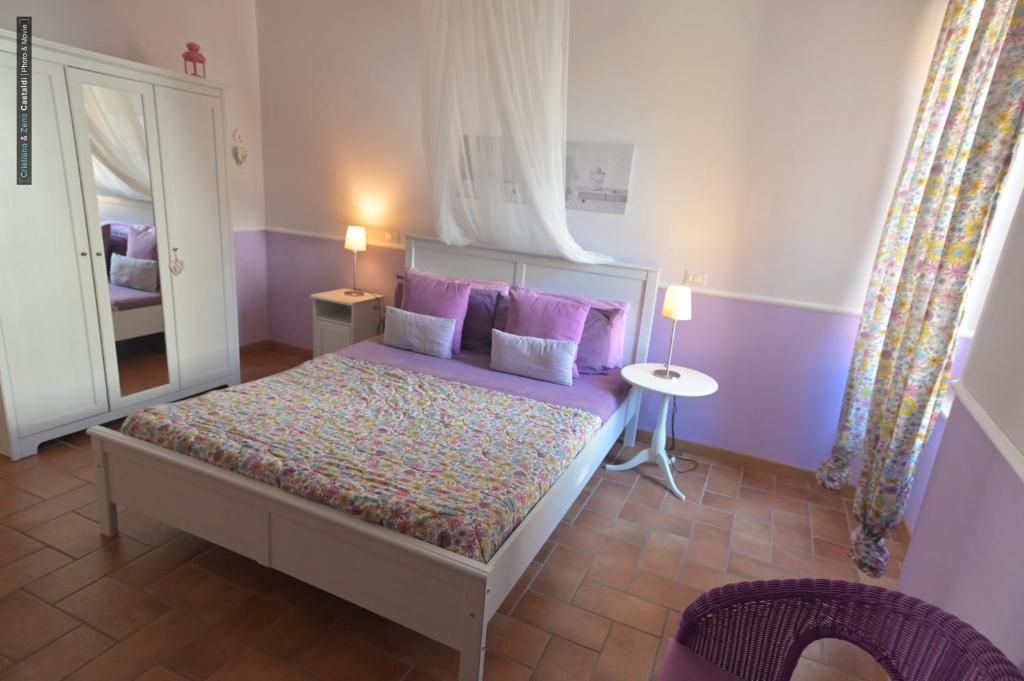 Postel nebo postele na pokoji v ubytování B&B Dimora Paolina