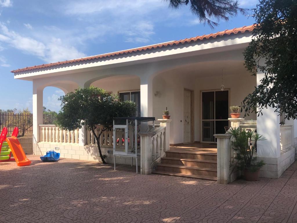 a small house with a porch and a playground at Villa Giovanna in Nardò