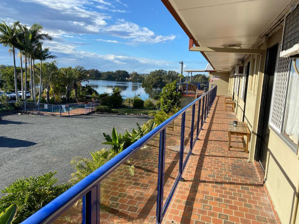 a balcony with a view of a body of water at Taree Motor Inn in Taree