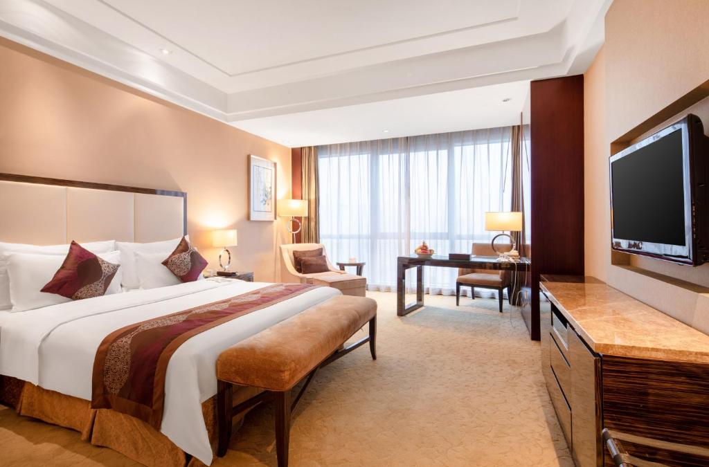 Postel nebo postele na pokoji v ubytování Shenzhen L.gem Hotel