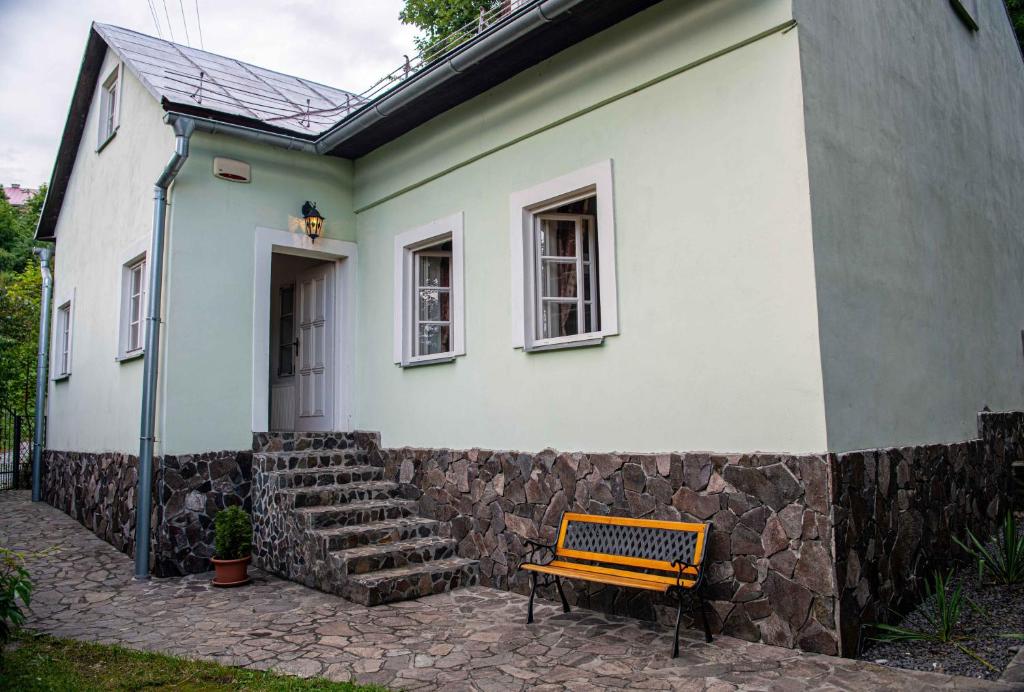 a bench sitting in front of a house at Holiday Home Banská Štiavnica in Banská Štiavnica