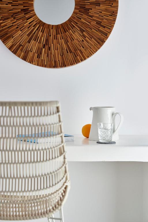 a white table with a chair and a mirror at Santa Maria Luxury Suites & Spa in Adamas