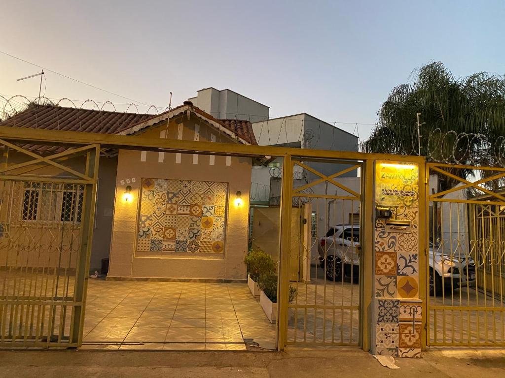 a house with a gate in front of it at Hostel Zampollo in Goiânia