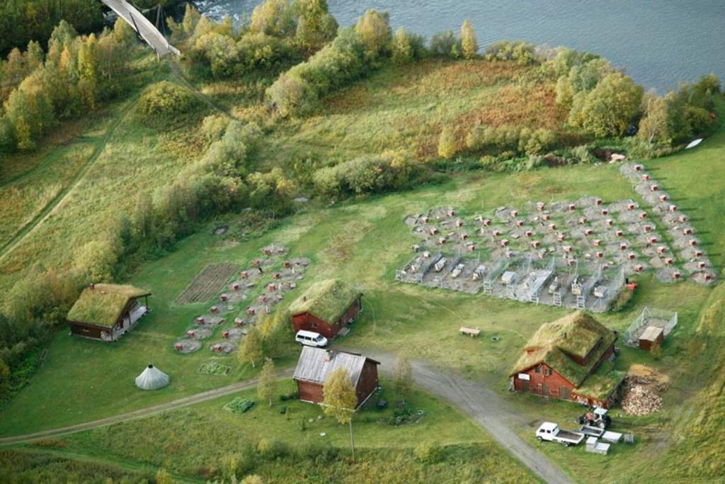 an aerial view of a farm with a bunch of buildings at Guesthouse / Huskyfarm Innset in Innset