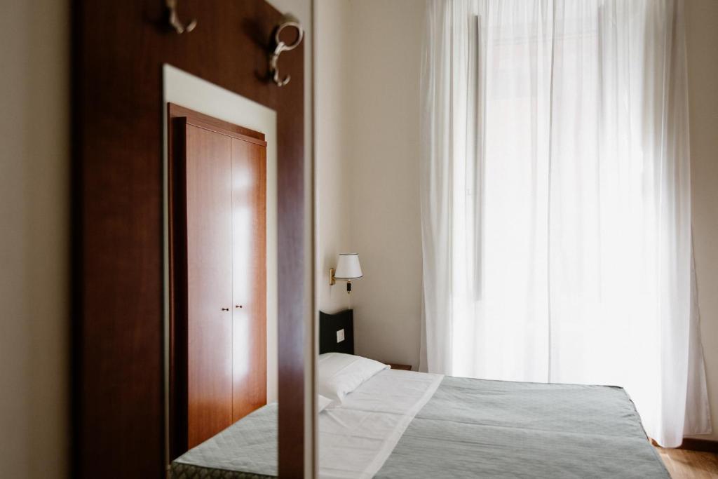 A bed or beds in a room at La Girandola Bed & Breakfast