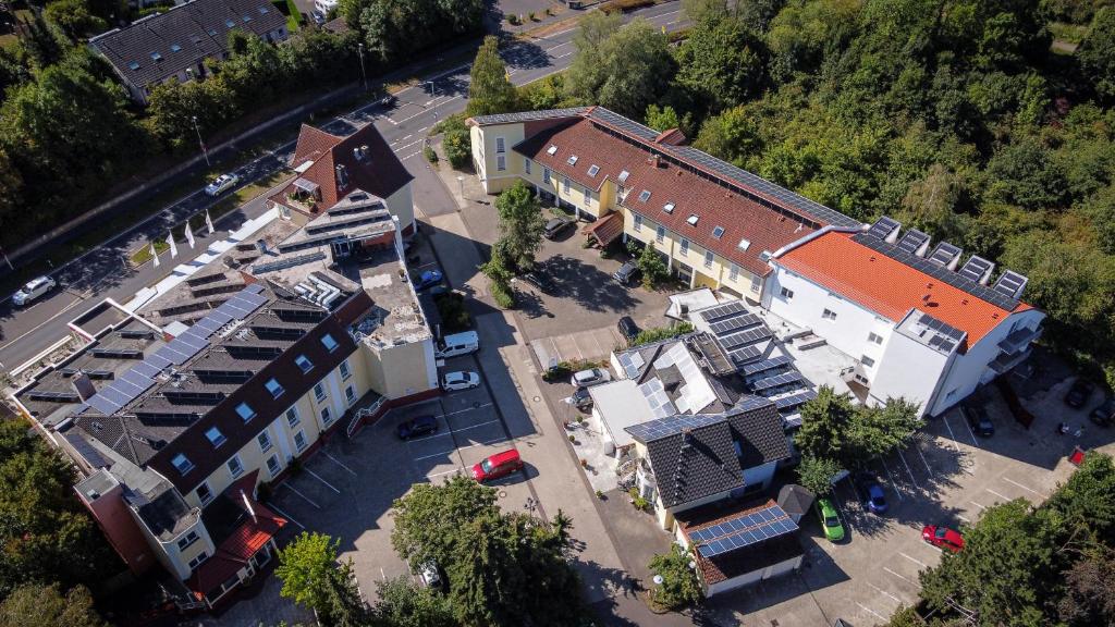 an overhead view of a building with a parking lot at City Hotel Meckenheim in Meckenheim