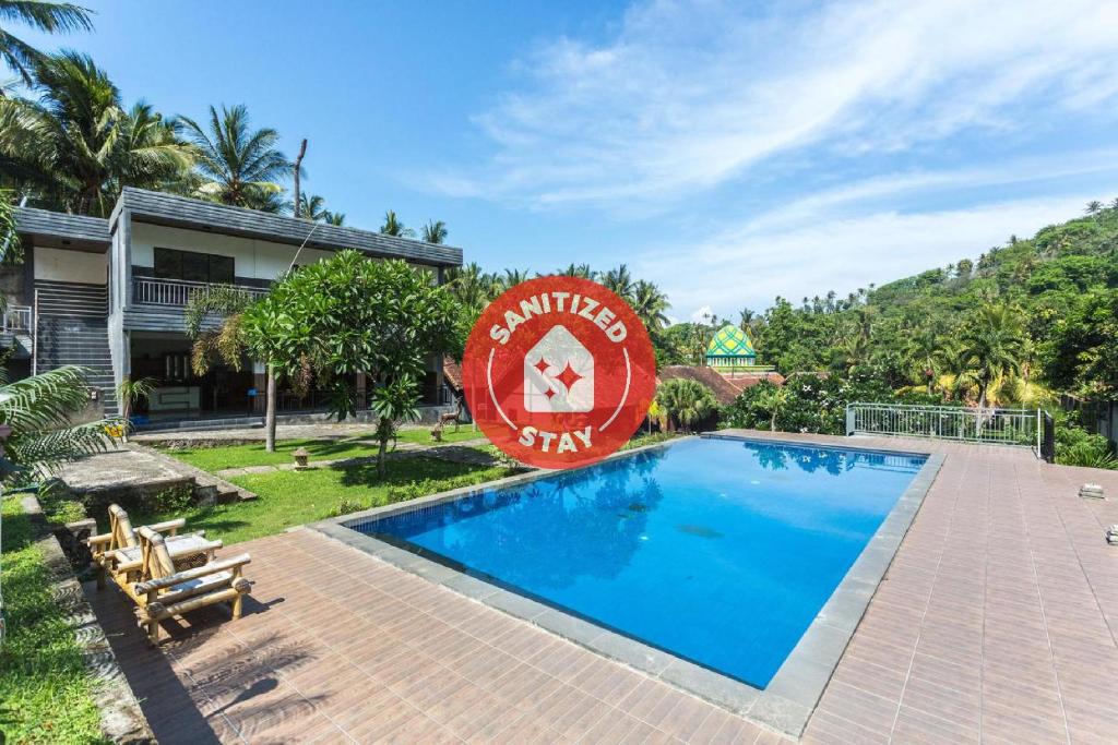 a resort with a swimming pool in front of a building at Hotel Bumi Aditya in Senggigi