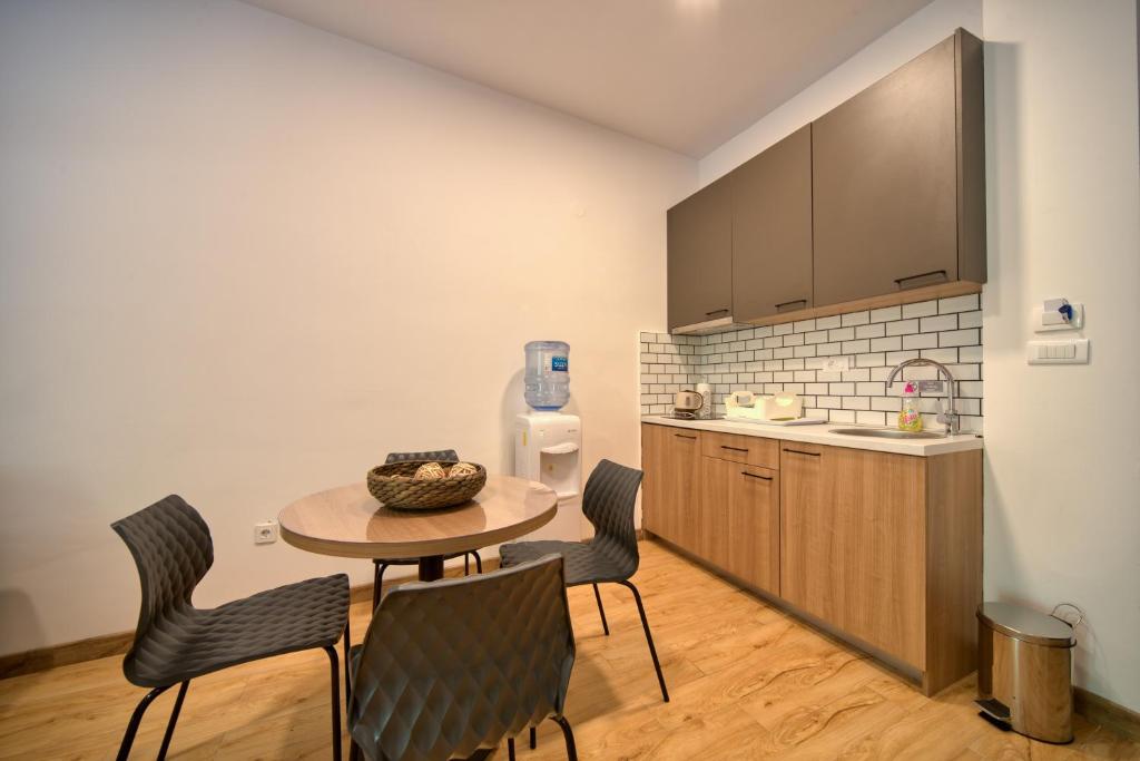 a kitchen with a table and chairs in a room at Trsteno Beach Apartments in Budva