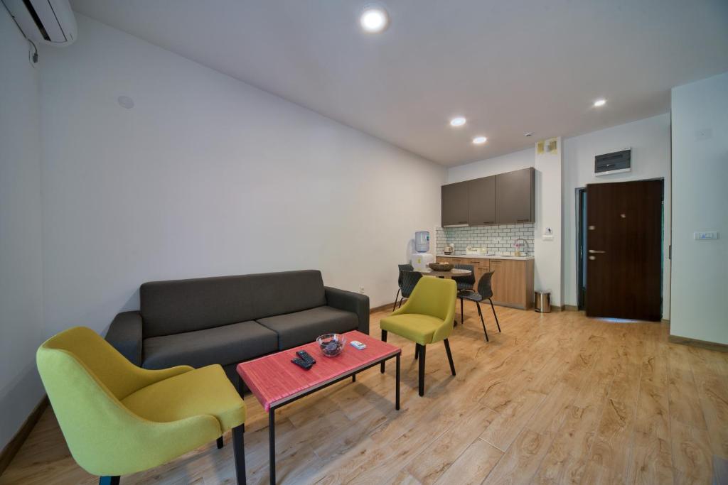 a living room with a couch and chairs and a table at Trsteno Beach Apartments in Budva