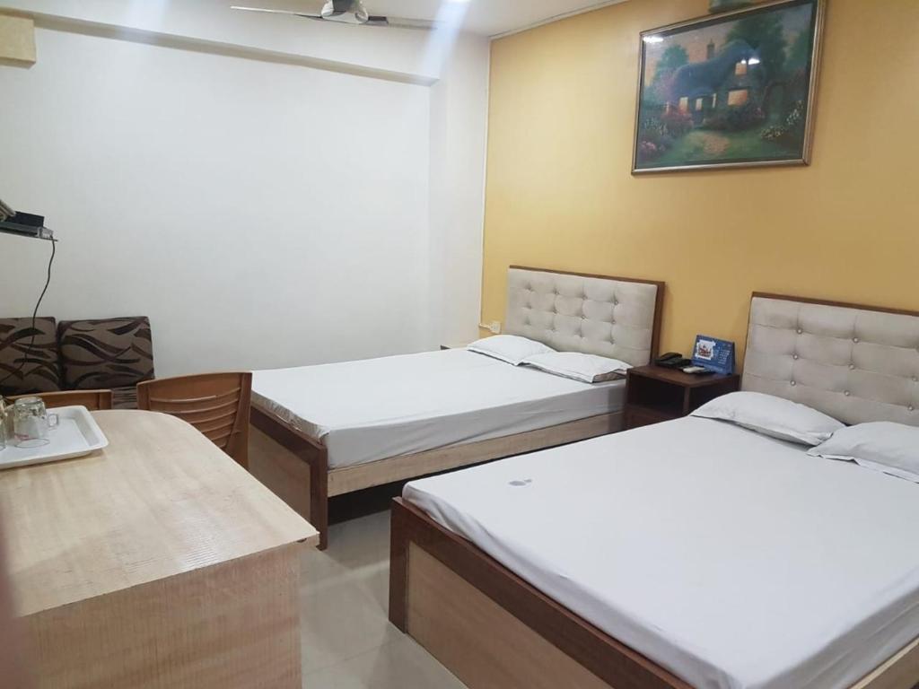 Postel nebo postele na pokoji v ubytování Jimmy Guest House