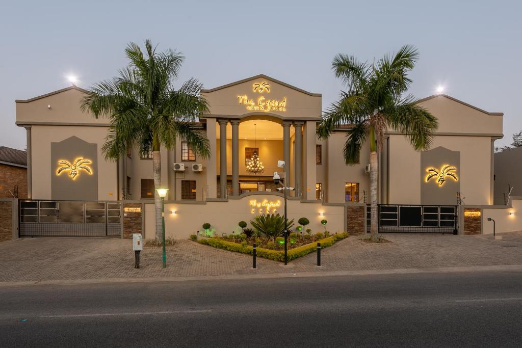 a building with a sign that reads mardi gras at The Cycad Lodge & Chalets in Nelspruit