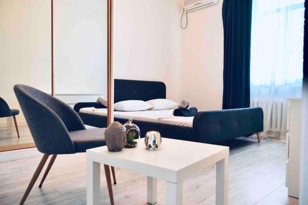 a living room with a couch and a table at White&Light flat near Gulliver in Kyiv