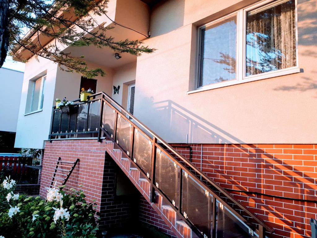 a house with a staircase leading up to a building at Ubytovanie u Marty in Veľký Meder