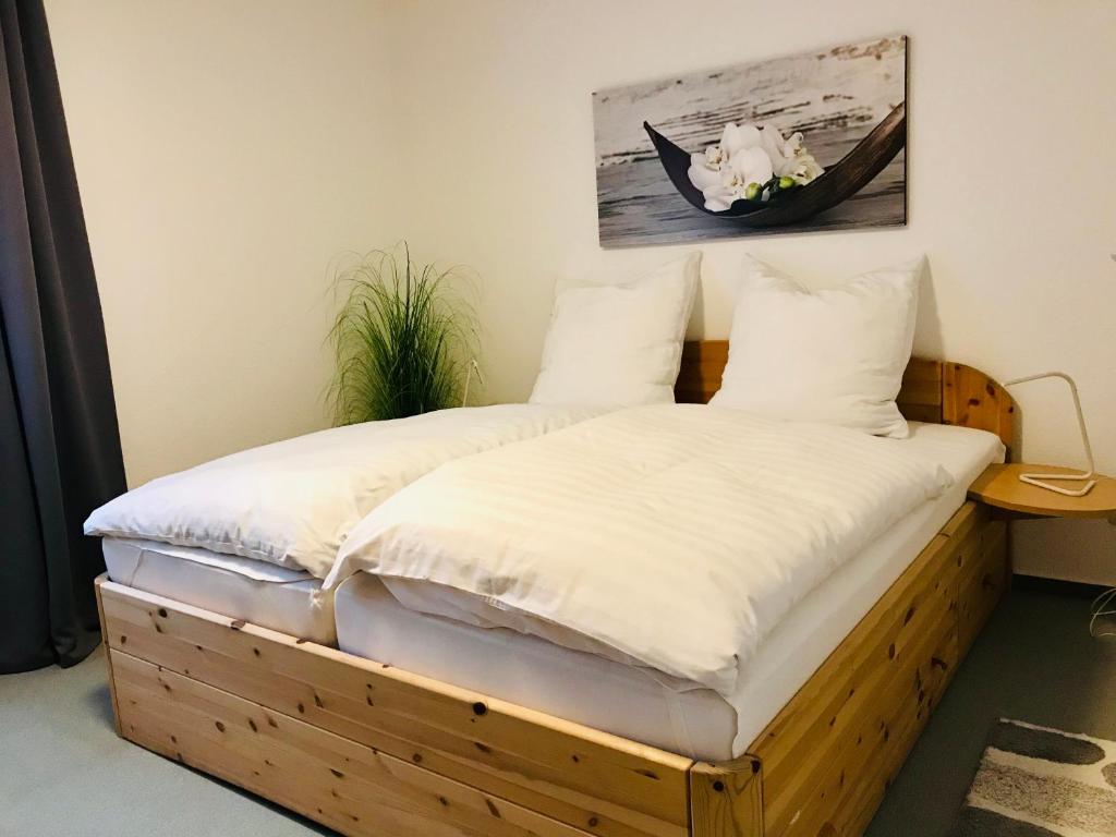 a bedroom with two beds with white sheets at Große Wohnung - Kamin - Balkon - Boxspringbett - Skiwiese in Braunlage