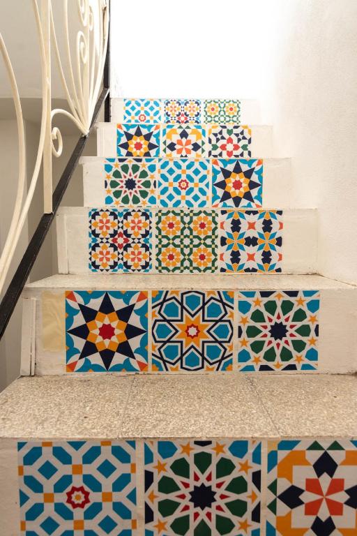 a set of stairs with colorful tiles on them at La Casetta sul Mare in Isola delle Femmine