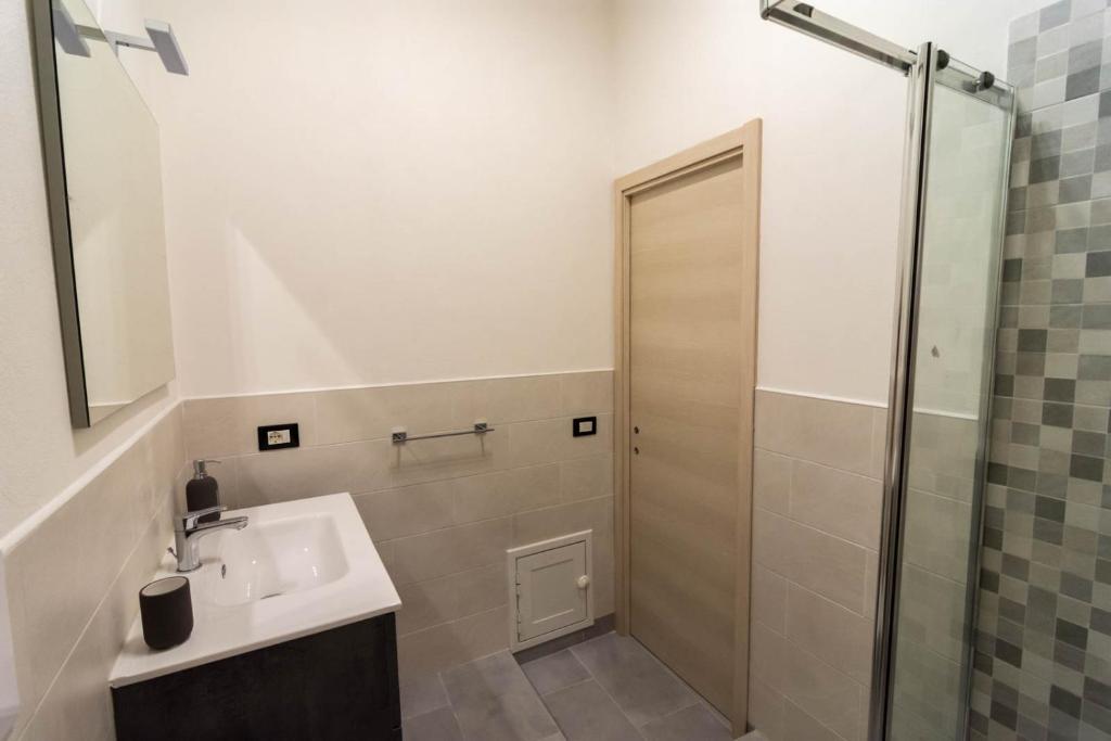 a bathroom with a sink and a shower at La Casetta sul Mare in Isola delle Femmine