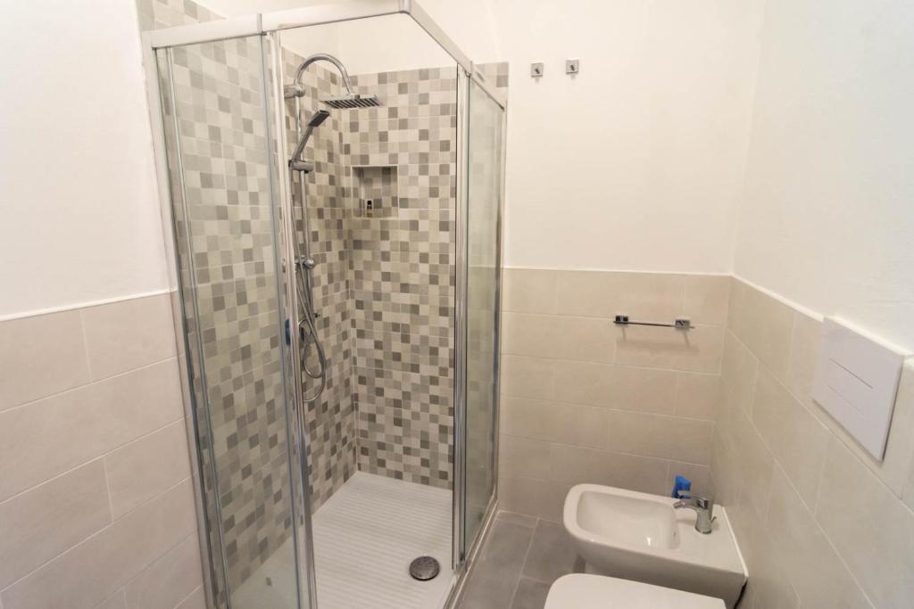 a bathroom with a shower and a toilet and a sink at La Casetta sul Mare in Isola delle Femmine