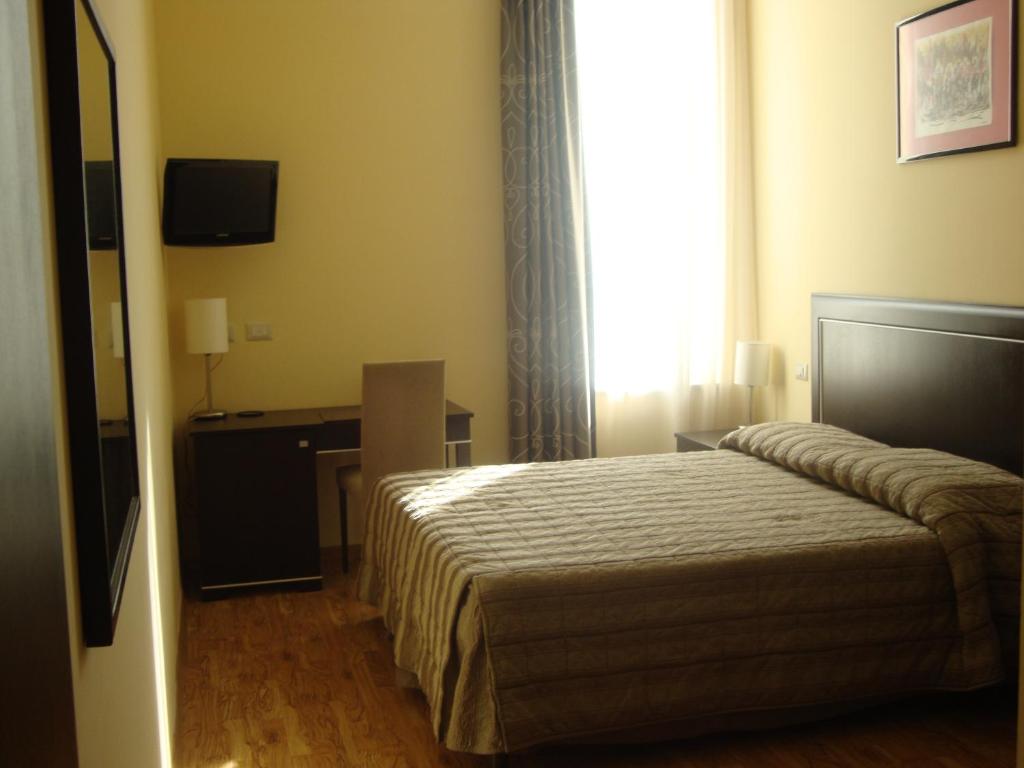 Postel nebo postele na pokoji v ubytování Hotel Villa Cinzia