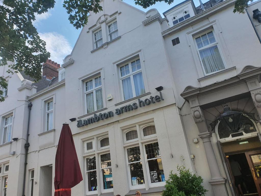 a white building with a hammond arms hotel on it at The Lambton Arms in Durham