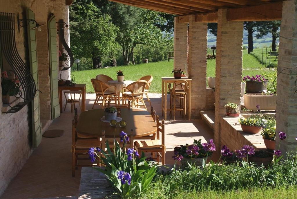 a patio with a table and chairs under a pavilion at Agriturismo Vellaneta in Cagli