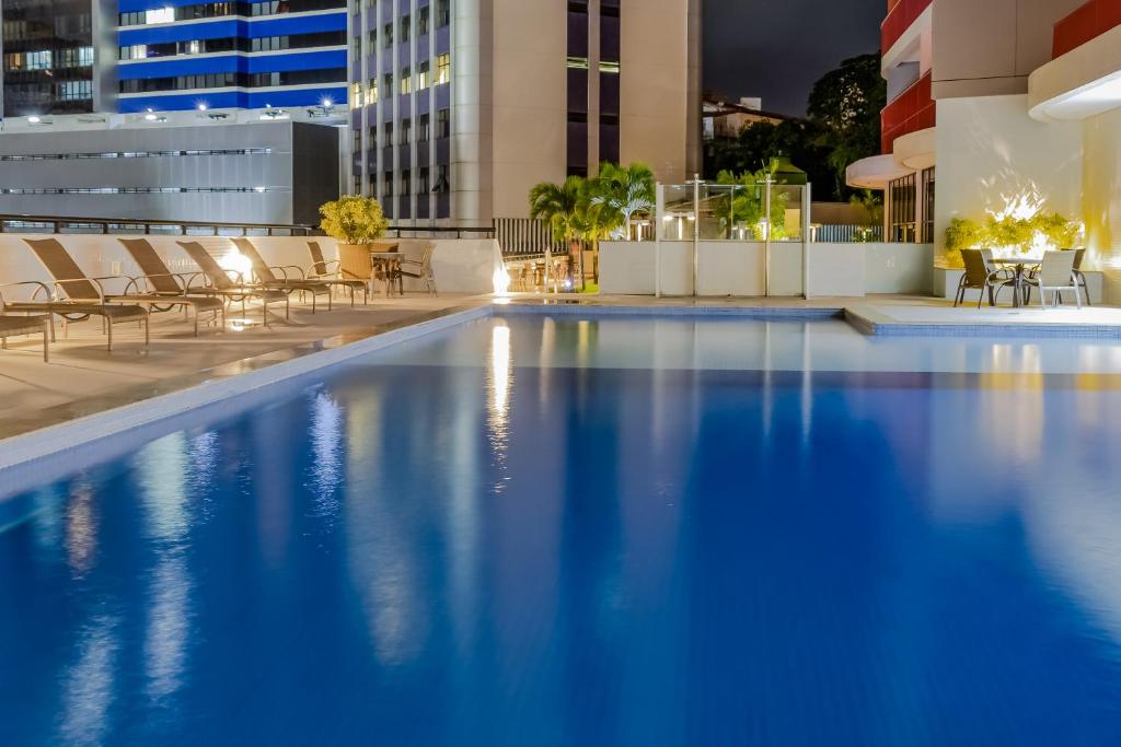 a swimming pool on the roof of a building at Mercure Salvador Boulevard Hotel in Salvador