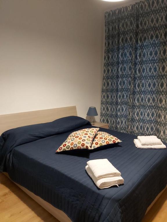 sypialnia z niebieskim łóżkiem i dwiema poduszkami w obiekcie Casa Giulia Vacanze w mieście Baronissi