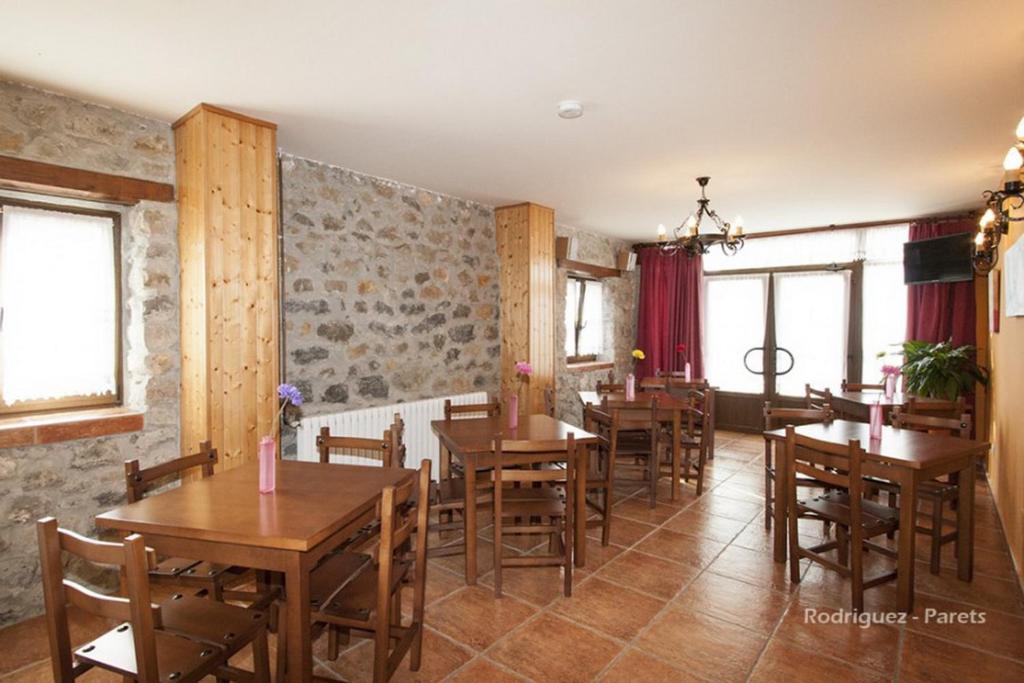 a dining room with wooden tables and chairs at El Pradón in Mar
