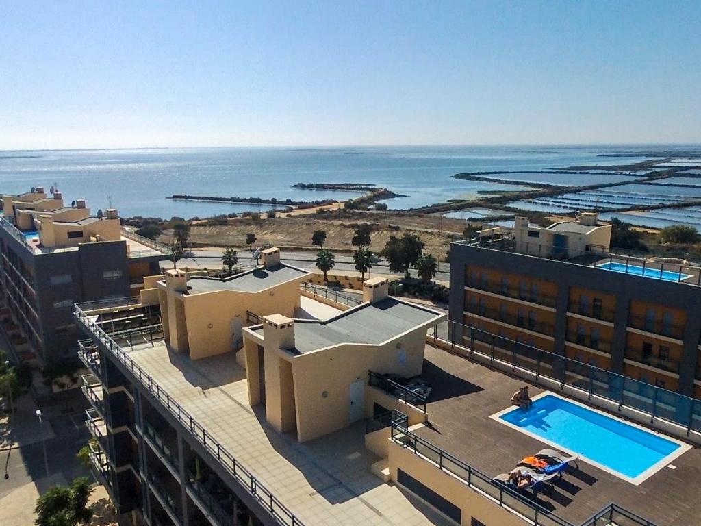 an aerial view of a building and the ocean at Beautiful Apartment in Olhão