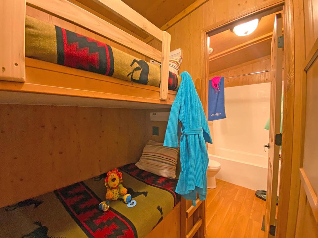 a bunk bed with a teddy bear sitting on the bottom bunk at Healing Waters Resort and Spa in Pagosa Springs