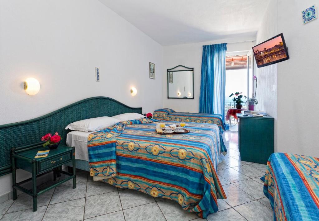 Letto o letti in una camera di Parco Residence La Rosa