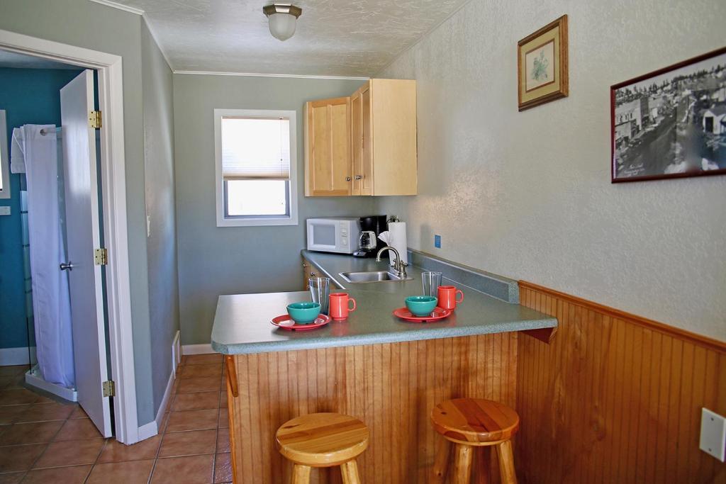a kitchen with a counter and two stools in it at Healing Waters Resort and Spa in Pagosa Springs