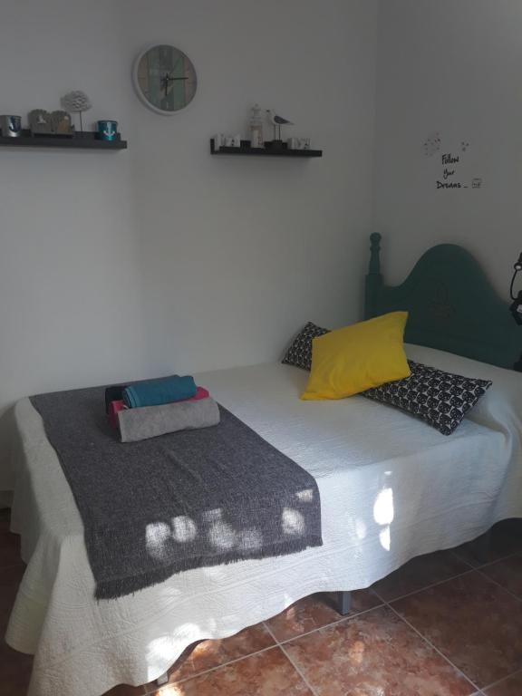 a bed sitting in a room with at El patio de Villa Pancho in Chipiona
