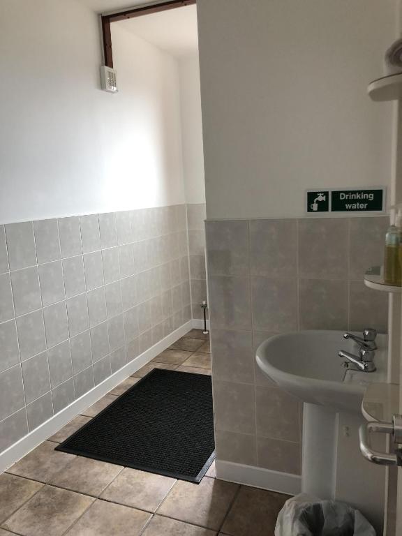 a small bathroom with a sink and a sink at Breeze Guest House in Bootle