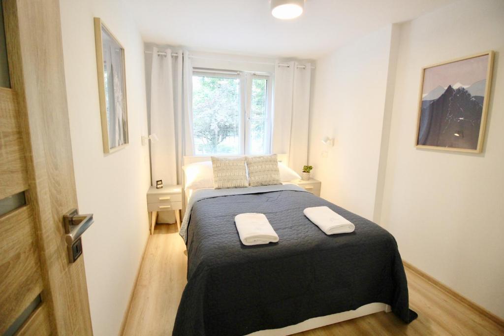 Posteľ alebo postele v izbe v ubytovaní Apartment BazaTatry Parkowy