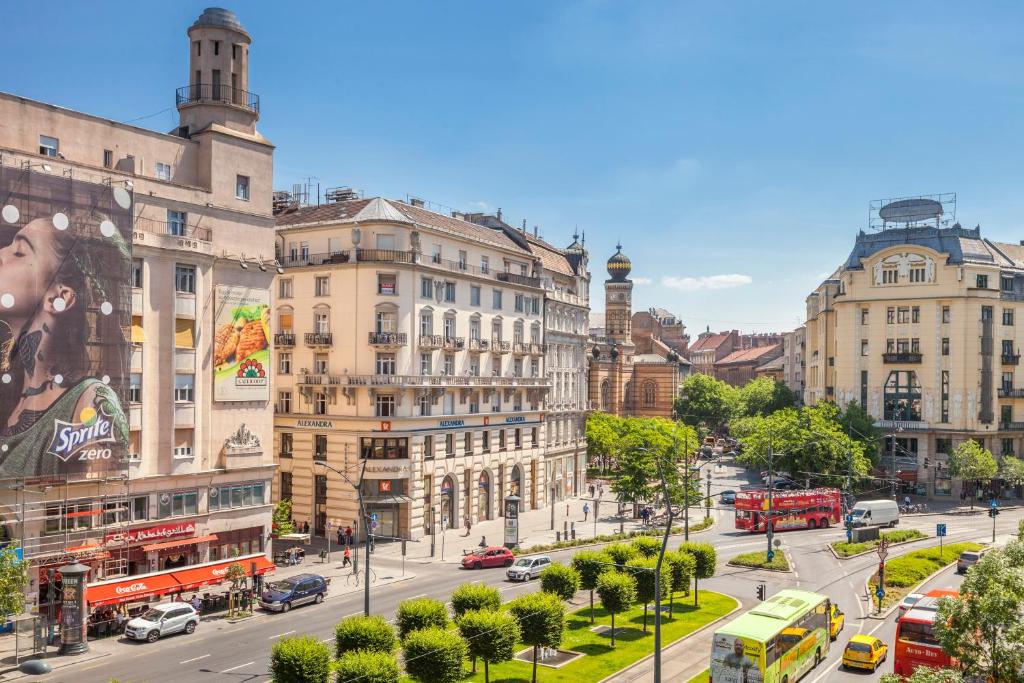 a busy city street with cars and buses at MODERNIZED Unique Huge Central Apartment On 135sqm in Budapest