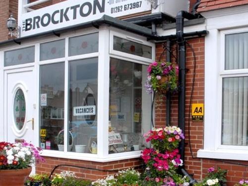 a store with flowers in the window of a brick building at The Brockton in Bridlington