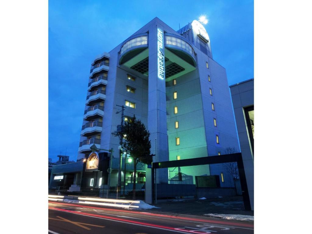 a tall building with a street in front of it at Hotel AreaOne Obihiro in Obihiro